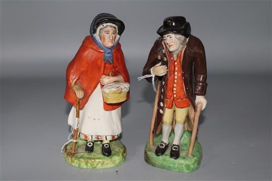 A pair of Staffordshire pearlware figures of an elderly lady and gentleman, c.1830, height 18cm (7.1in.), restorations